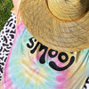 man lounging in a smooj tie-dye tee
