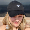 blond woman wearing a black smooj hat